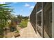 Backyard with a screened lanai and a lush lawn at 3411 Eisenhower Way, The Villages, FL 32163