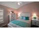 Charming bedroom featuring a white bed frame, dresser, and cool, coastal-themed decor at 3411 Eisenhower Way, The Villages, FL 32163