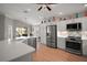 Modern kitchen with stainless steel appliances, white cabinetry, and a large central island at 3411 Eisenhower Way, The Villages, FL 32163
