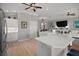 Bright, open-concept kitchen featuring a white island and views to the living room at 3411 Eisenhower Way, The Villages, FL 32163