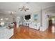 Spacious and brightly lit living room with hardwood floors, contemporary decor, and comfortable seating arrangement at 3411 Eisenhower Way, The Villages, FL 32163