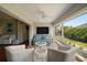 Bright sunroom features neutral-toned decor, ample sunlight, and views of the lush outdoors at 3411 Eisenhower Way, The Villages, FL 32163