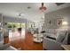 Spacious living room with hardwood floors, neutral furniture, and open layout to the kitchen at 3411 Eisenhower Way, The Villages, FL 32163