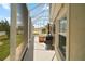 Covered screened patio featuring grill and outdoor seating, perfect for al fresco dining at 3411 Eisenhower Way, The Villages, FL 32163