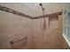Close-up of newly tiled shower with decorative border and convenient built-in shelf at 3411 Eisenhower Way, The Villages, FL 32163