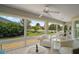 Bright sunroom with large windows offering panoramic views of the well-manicured lawn and landscaping at 3411 Eisenhower Way, The Villages, FL 32163