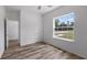 Bedroom with wood-look flooring, a large window and a ceiling fan at 40685 E Ninth Ave, Umatilla, FL 32784
