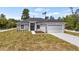 Charming single-story home featuring stone accents, a two-car garage, and a well-manicured lawn at 40685 E Ninth Ave, Umatilla, FL 32784