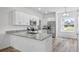 Well-lit kitchen with white cabinets, stainless steel appliances, and granite countertops at 40685 E Ninth Ave, Umatilla, FL 32784
