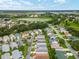 Scenic aerial shot of a charming neighborhood featuring well-maintained homes and a serene lake in the background at 412 Hildalgo Dr, The Villages, FL 32159