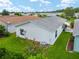 Charming backyard featuring a well-maintained lawn, a patio, and glimpses of neighboring homes at 412 Hildalgo Dr, The Villages, FL 32159