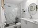 Bathroom featuring a glass shower with marble-style tiling at 412 Hildalgo Dr, The Villages, FL 32159