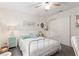 Bedroom features white bedding, a ceiling fan, and large windows at 412 Hildalgo Dr, The Villages, FL 32159