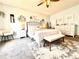 A lovely bedroom with white furniture and a stylish rug at 412 Hildalgo Dr, The Villages, FL 32159