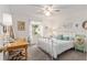 Cozy bedroom with soft decor, a desk, and a ceiling fan at 412 Hildalgo Dr, The Villages, FL 32159