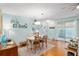 Well-lit dining room with a sliding glass door, wood floors, and light walls at 412 Hildalgo Dr, The Villages, FL 32159