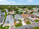 Beautifully landscaped front exterior featuring a well-manicured lawn, palm trees, and a charming white picket fence at 412 Hildalgo Dr, The Villages, FL 32159