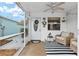 Cozy screened porch with comfortable seating, stylish decor, and a ceiling fan for added comfort at 412 Hildalgo Dr, The Villages, FL 32159