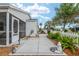 Beautifully landscaped front yard with concrete walkway, decorative garden features, and lush greenery at 412 Hildalgo Dr, The Villages, FL 32159