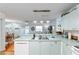 Bright open concept kitchen with stainless steel sink and adjacent dining and living spaces at 412 Hildalgo Dr, The Villages, FL 32159