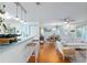 Open floor plan showcasing a kitchen bar, hardwood floors, and a naturally lit living area at 412 Hildalgo Dr, The Villages, FL 32159