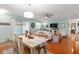 Bright open floor plan featuring dining and living spaces with hardwood floors and a sliding glass door to the yard at 412 Hildalgo Dr, The Villages, FL 32159