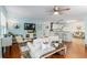 Inviting living room open to kitchen, featuring hardwood floors, comfortable seating, and a television at 412 Hildalgo Dr, The Villages, FL 32159