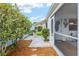 Cozy side yard patio area with a table and chairs, perfect for outdoor dining and relaxation at 412 Hildalgo Dr, The Villages, FL 32159
