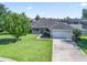 Overhead view of a well-maintained single-story home with a large lawn and attached two-car garage at 4730 Se 31St St, Ocala, FL 34480