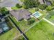 A lush green lawn and a sparkling pool, create a serene backyard oasis, with a privacy fence for peaceful enjoyment at 4730 Se 31St St, Ocala, FL 34480