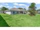 Lush backyard with a covered patio, offering an ideal space for outdoor entertaining and relaxation at 4730 Se 31St St, Ocala, FL 34480