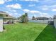 Expansive, well-maintained backyard with a white fence, featuring a covered patio and plenty of green space at 4730 Se 31St St, Ocala, FL 34480