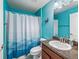 Bathroom with colorful blue walls, a toilet, vanity, and a shower curtain at 4730 Se 31St St, Ocala, FL 34480