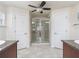 Bright bathroom featuring tiled flooring, double doors, and a glass-enclosed shower with modern fixtures at 4730 Se 31St St, Ocala, FL 34480