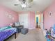 Spacious bedroom with neutral carpet and pink walls at 4730 Se 31St St, Ocala, FL 34480