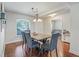 Charming dining room with hardwood floors, overhead light, and a view to the adjoining spaces at 4730 Se 31St St, Ocala, FL 34480