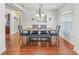 Cozy dining room featuring a chandelier and wooden floors, perfect for intimate gatherings at 4730 Se 31St St, Ocala, FL 34480
