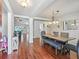 Elegant dining room with hardwood floors, stylish chandelier, and a view into the living room at 4730 Se 31St St, Ocala, FL 34480