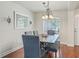 Bright dining room with a window and chair rail, illuminated by chandelier, and stylish wooden table at 4730 Se 31St St, Ocala, FL 34480