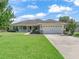 Charming single-story home with a well-manicured lawn and two-car garage, offering great curb appeal at 4730 Se 31St St, Ocala, FL 34480