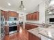 Kitchen featuring granite counters, stainless appliances and dark wood cabinets at 4730 Se 31St St, Ocala, FL 34480