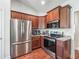 Kitchen featuring stainless appliances, granite counters, and dark wood cabinets at 4730 Se 31St St, Ocala, FL 34480