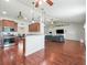 Open-concept kitchen and living room with stainless appliances, hardwood flooring, and pendant lighting at 4730 Se 31St St, Ocala, FL 34480
