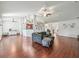 Spacious living room featuring wood floors, ceiling fan, and a comfortable seating area at 4730 Se 31St St, Ocala, FL 34480