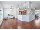 Open-concept living room and kitchen featuring hardwood floors and modern lighting fixtures at 4730 Se 31St St, Ocala, FL 34480