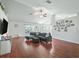 Bright and open living room with wood floors, ceiling fan, natural light, and comfortable seating at 4730 Se 31St St, Ocala, FL 34480