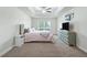 Spacious main bedroom features tray ceiling, large window and carpet flooring at 4730 Se 31St St, Ocala, FL 34480