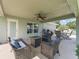 Relaxing covered patio with ceiling fan, outdoor seating, grill and backyard view at 4730 Se 31St St, Ocala, FL 34480