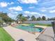 Inviting backyard pool with comfortable lounge chairs and lush landscaping under a bright blue sky at 4730 Se 31St St, Ocala, FL 34480