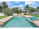 Sparkling backyard pool featuring a waterfall feature and lounge chairs, perfect for relaxation at 4730 Se 31St St, Ocala, FL 34480